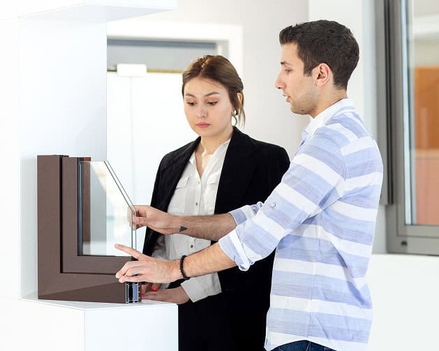 front-view-young-beautiful-lady-white-shirt-dark-jacket-black-trousers-along-with-young-man-discussing-something-daytime-building-job-activity 1